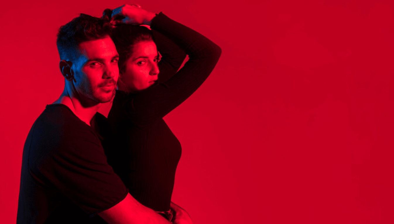 Stylish couple in a London-inspired red-lit portrait